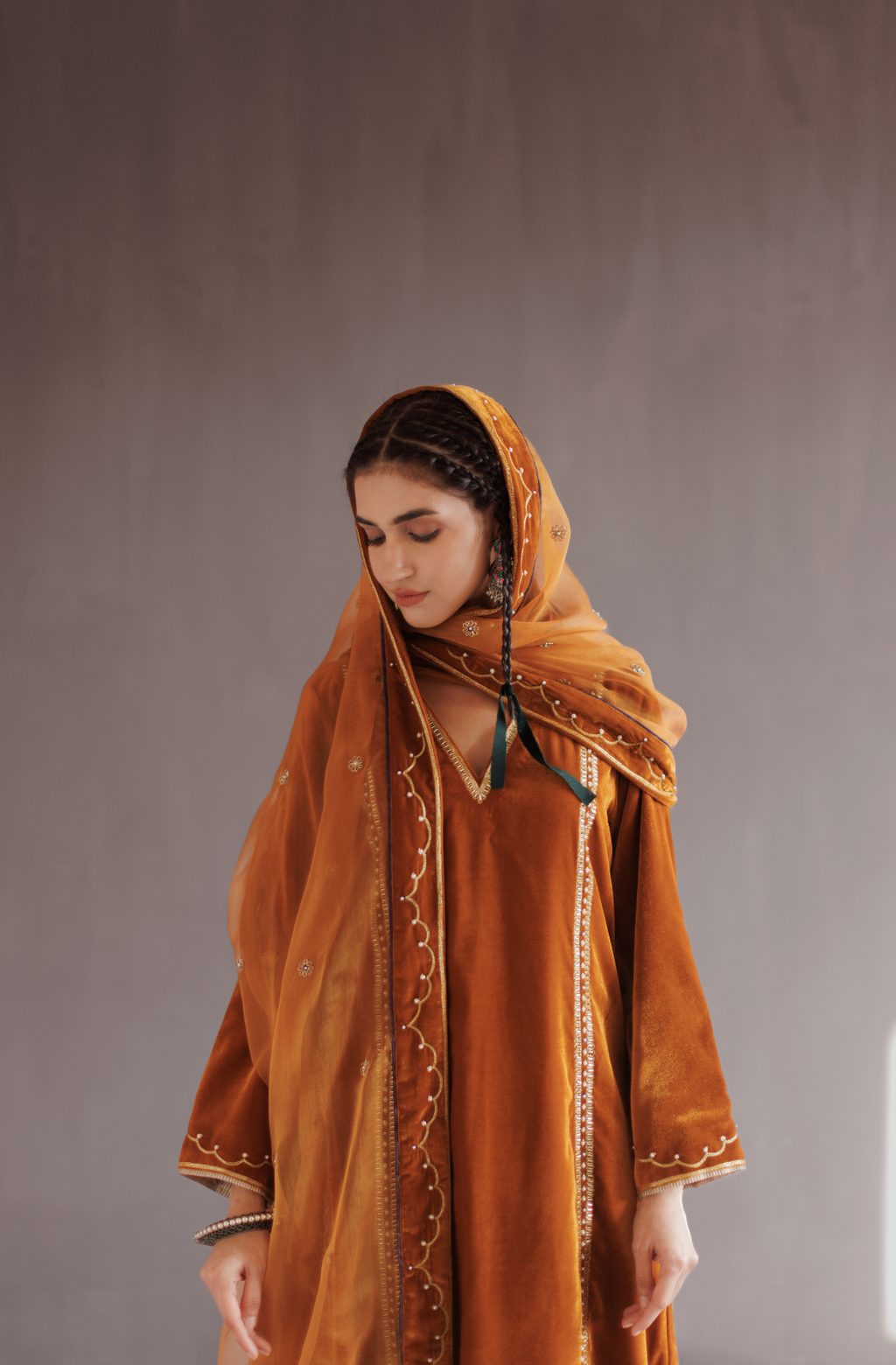 Mustard silk velvet hand embroidered kurta set.
