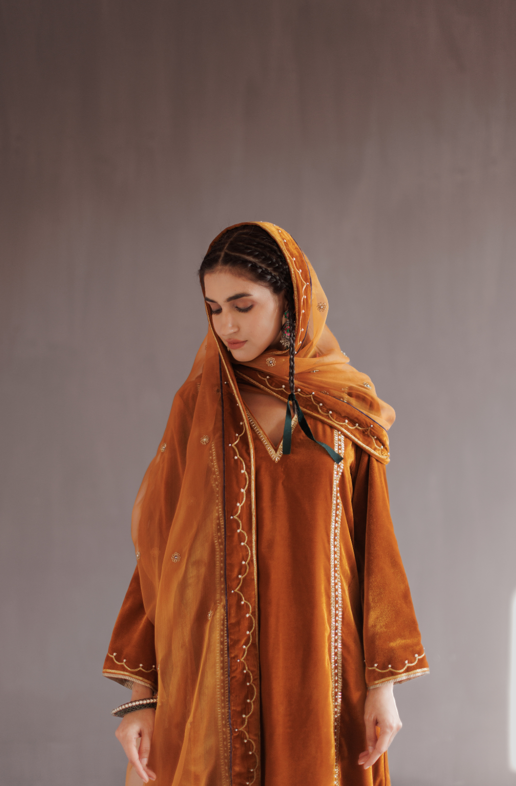 Mustard silk velvet hand embroidered kurta set.