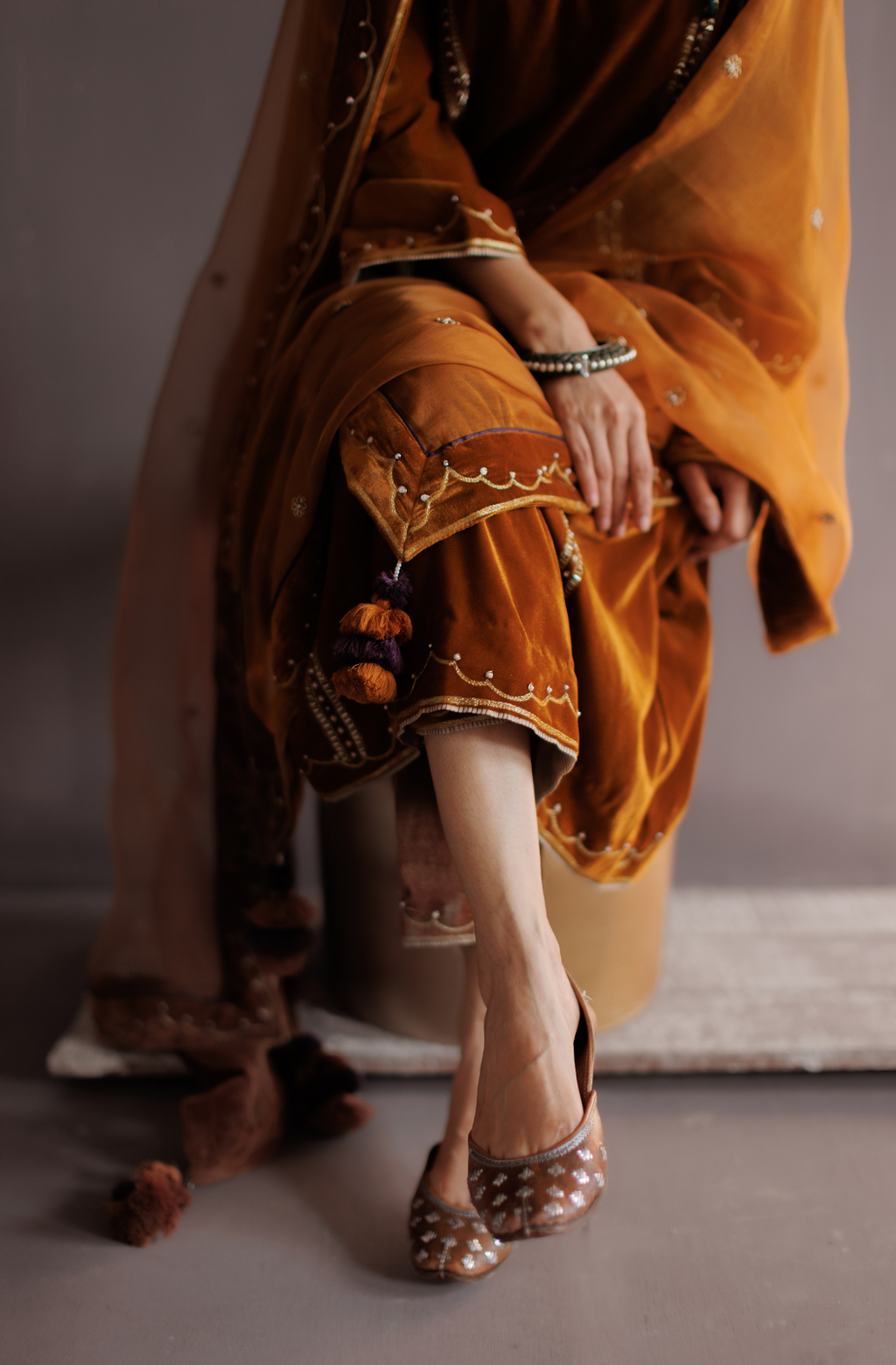 Mustard silk velvet hand embroidered kurta set.