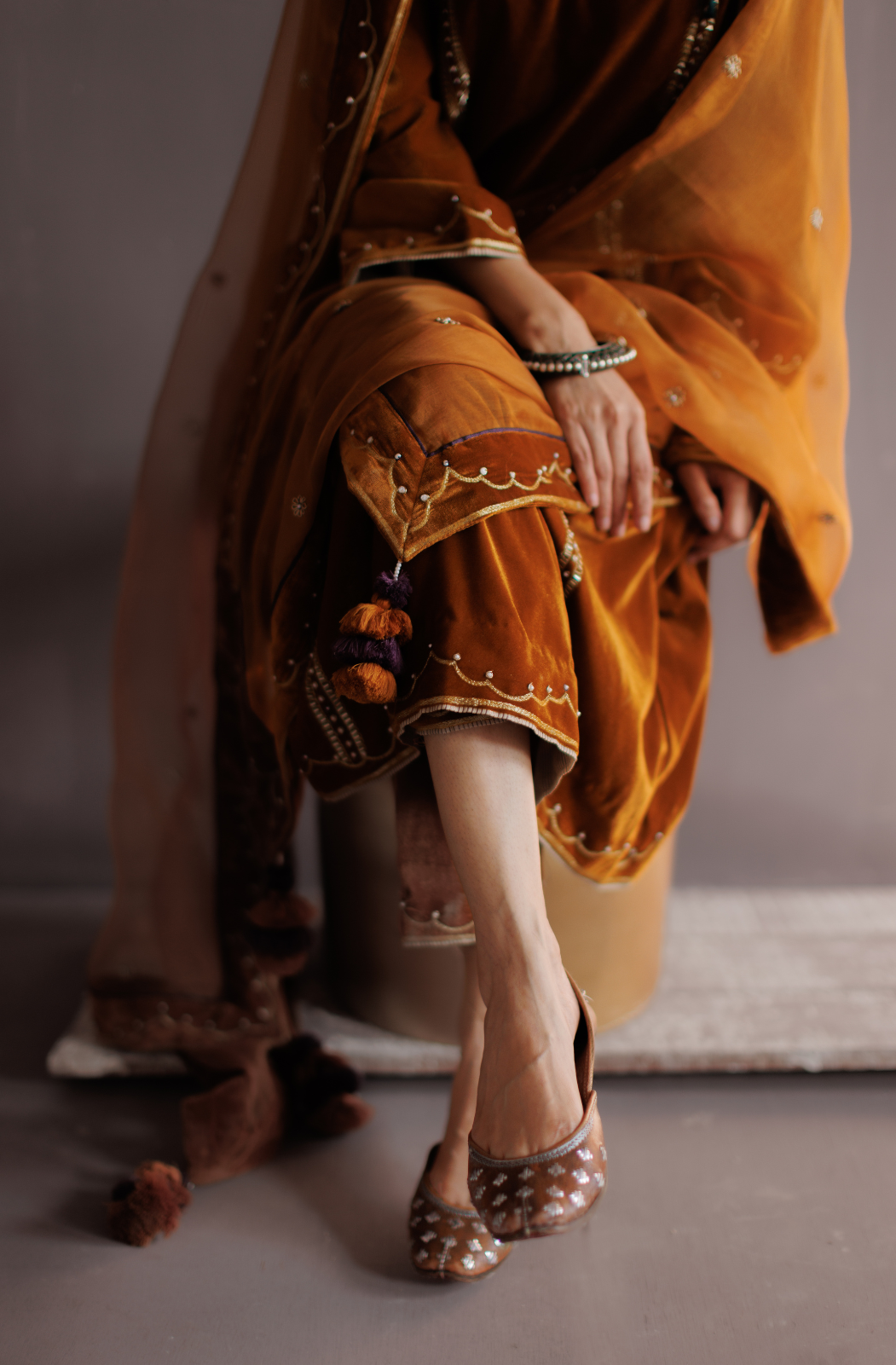 Mustard silk velvet hand embroidered kurta set.