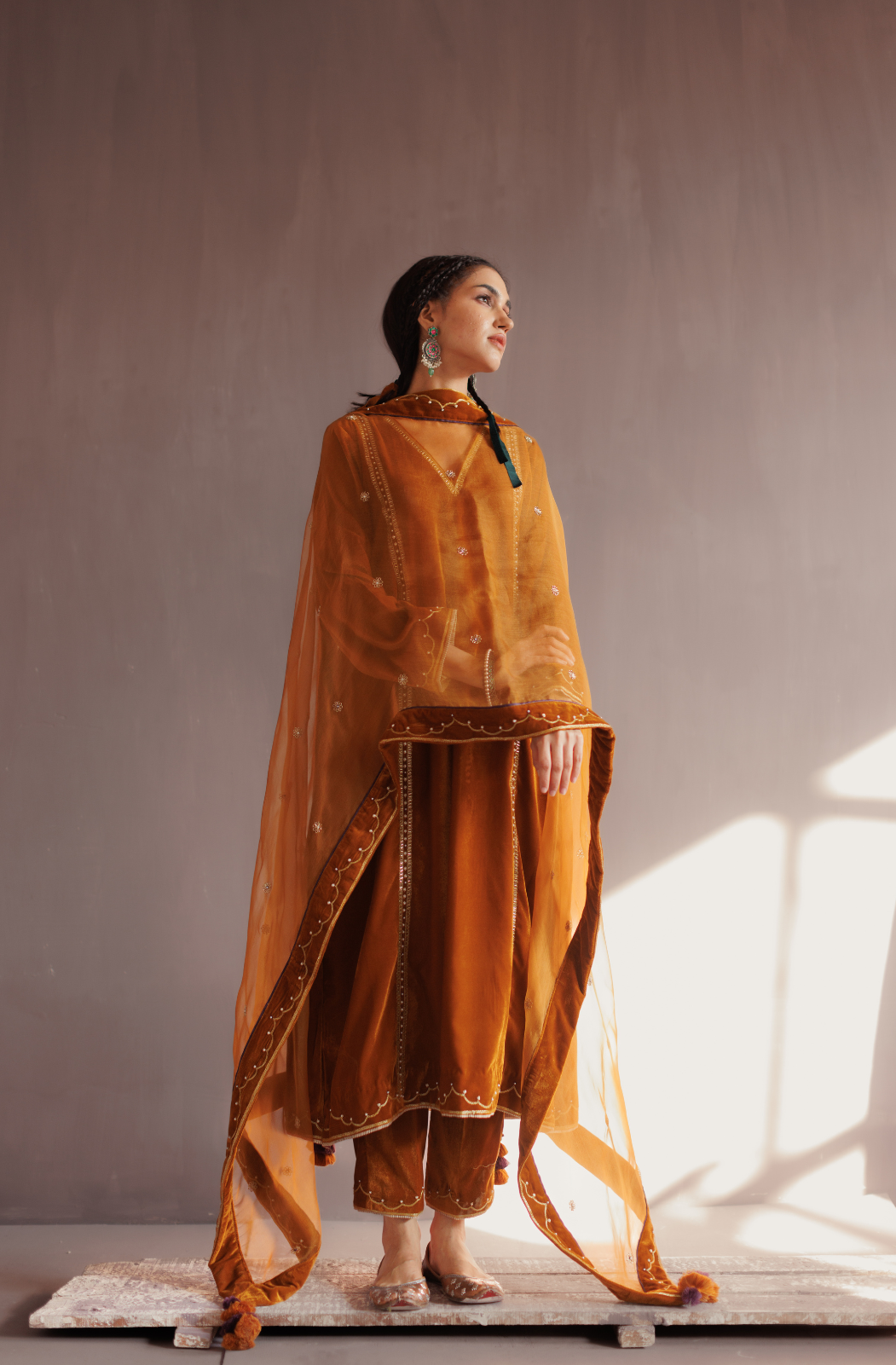 Mustard silk velvet hand embroidered kurta set.
