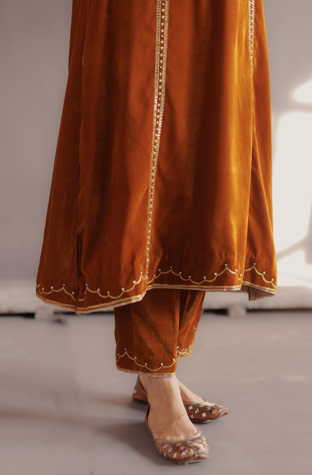 Mustard silk velvet hand embroidered kurta set.