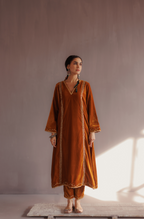 Mustard silk velvet hand embroidered kurta set.