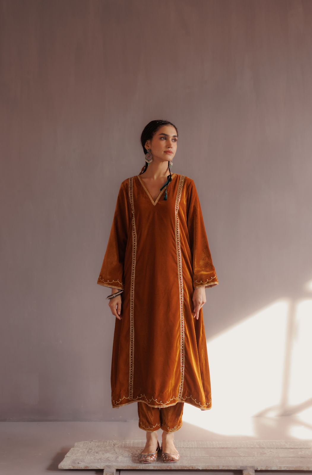 Mustard silk velvet hand embroidered kurta set.