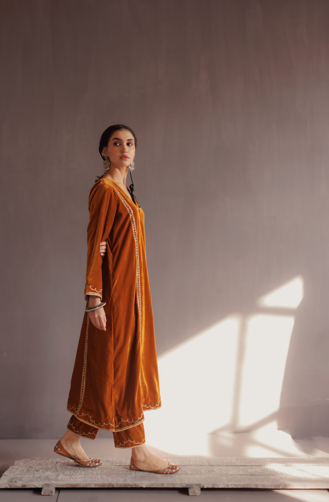 Mustard silk velvet hand embroidered kurta set.